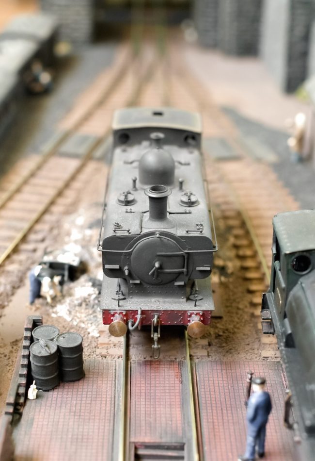 closeup of a model steam locomotive in a goods yard