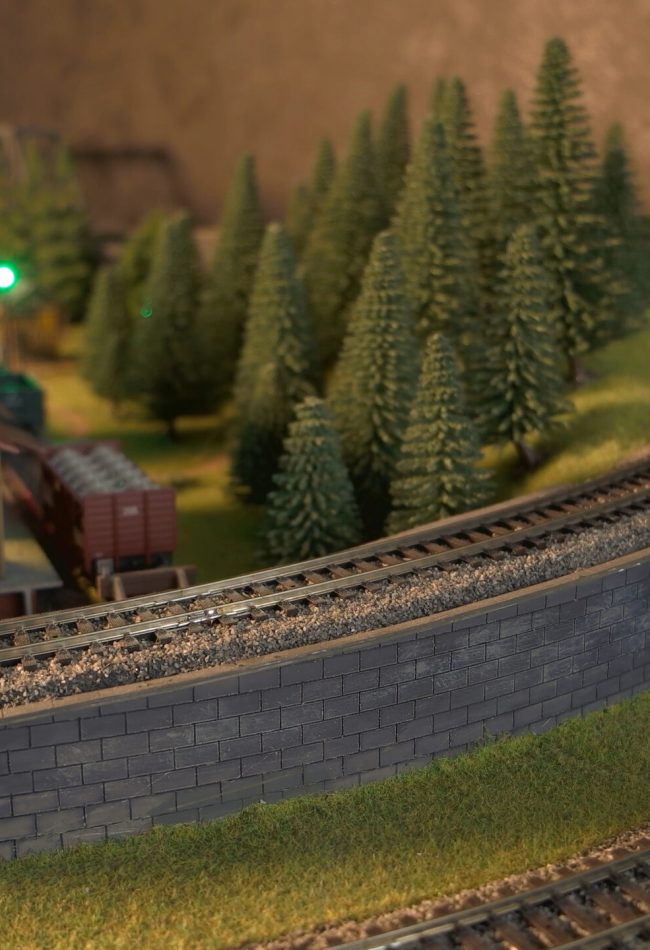 Retro lokomotive on a railroad. Replica train model of a railway station.