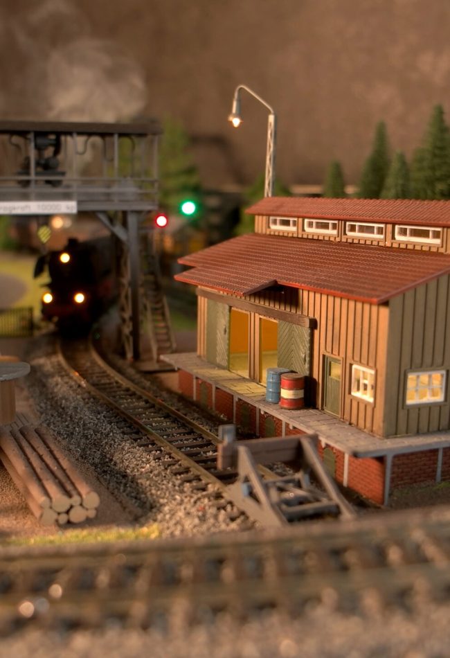 Retro railway depot replica. Miniature model of railroad and shed.