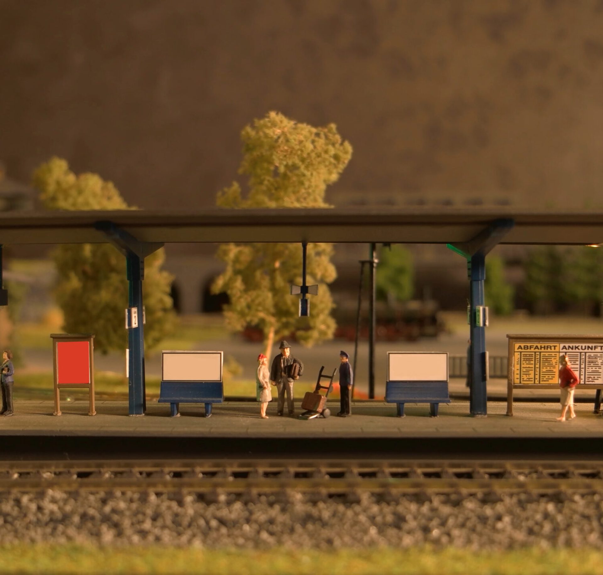 Retro railway station. People waiting for their train. Replica miniature model.